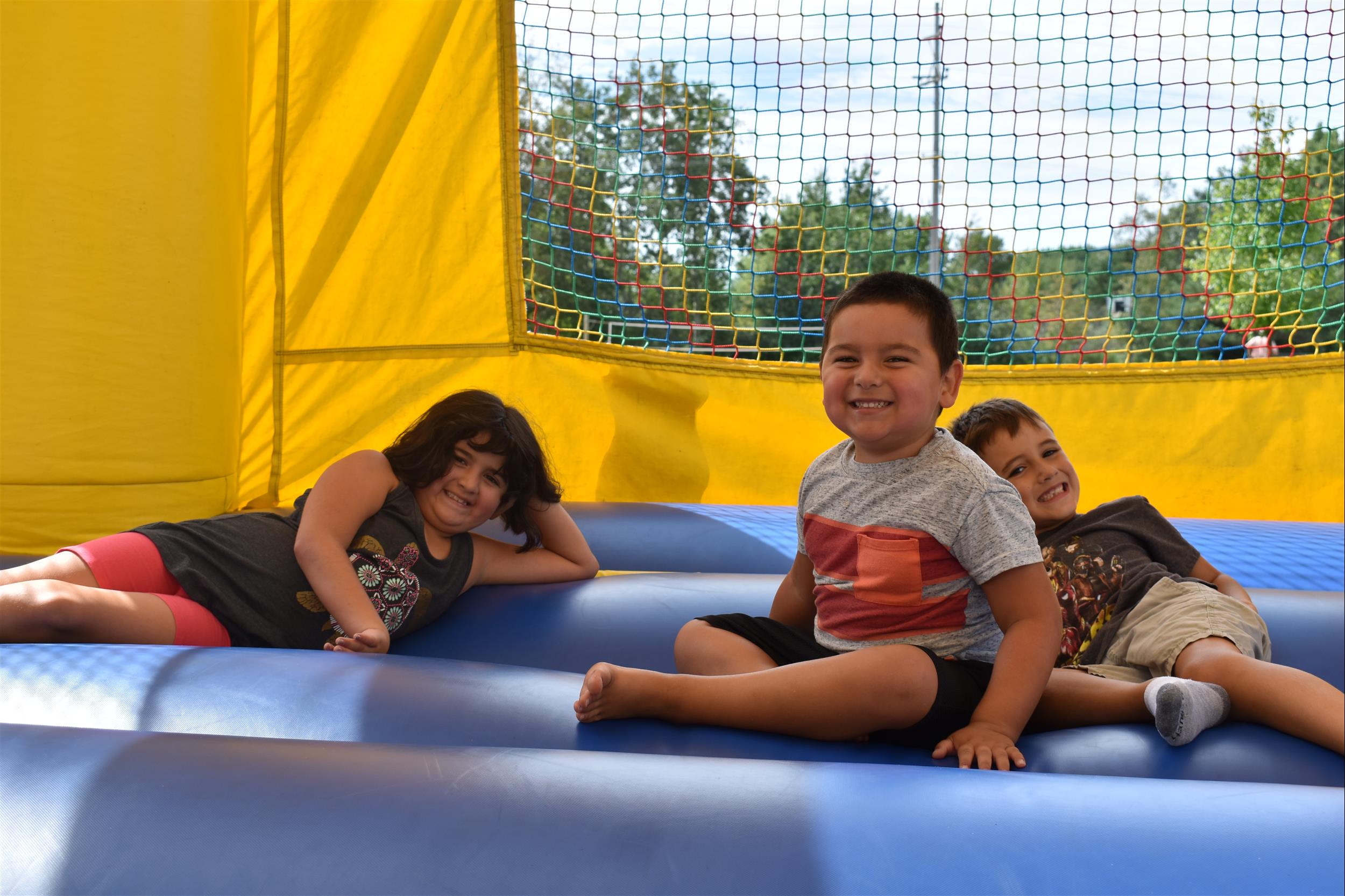 Three kids playing in bounce house